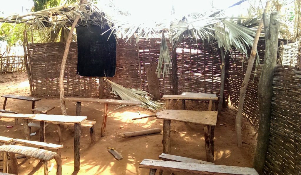 schools in Guinea-Bissau with dirt floors and wooden benches.