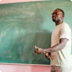 Teacher sharing in front of board