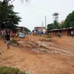 [2/3] View of the road leading to the Bissau campus before work was done. Torrential rain had damaged it to the point where a majority of sections were only passable for one direction of traffic and had so many washouts that public transportation was no longer able to operate on the road.