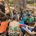 One of the team's activities included visiting the home village of Matilde Tavares Na Guile, the Finance and Administrative Assistant at the Bissau campus. Here, the team helps shell peanuts harvested in the village.