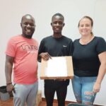 Tiofilu (center) with the Computer Literacy Program instructor, Dauda (left) and WAVS Country Director, Sloan (right).